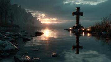 Sunset reflection near the ancient cross by the serene lake surrounded by misty mountains and rocky shoreline photo