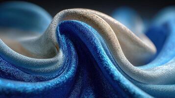Textured fabric waves in shades of blue and cream illuminated by soft light create an elegant and calming atmosphere photo