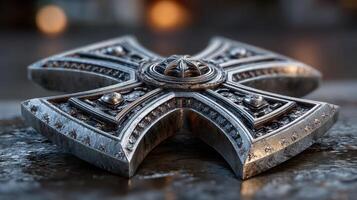 Intricate silver cross emblem displayed on textured surface with soft lighting in an artistic setting photo