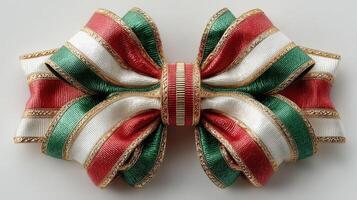 Decorative bow made with green, white, and red ribbons displayed on a neutral background photo