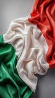 Italian flag draped elegantly on a smooth surface showcasing vibrant colors and intricate textures photo