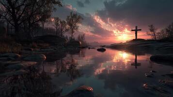 Serene sunset over a calm waterway with a cross silhouette and rocky shoreline photo