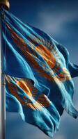 National flag of Kazakhstan waving elegantly in the breeze against a clear blue sky during the daytime photo