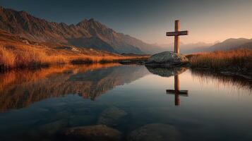 Cross reflection in serene mountain landscape at dawn with vibrant colors and tranquil water photo