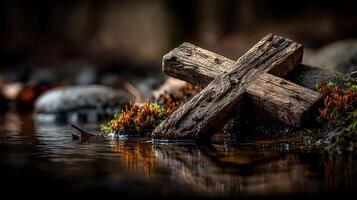Weathered wooden cross beside a tranquil stream reflecting soft autumn hues in a serene natural setting photo