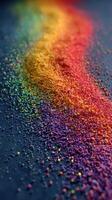 Colorful granules create a vibrant rainbow effect on a dark surface in artistic display photo