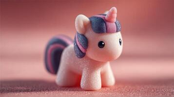 Cute pink unicorn toy with colorful mane and horn placed on a soft background photo