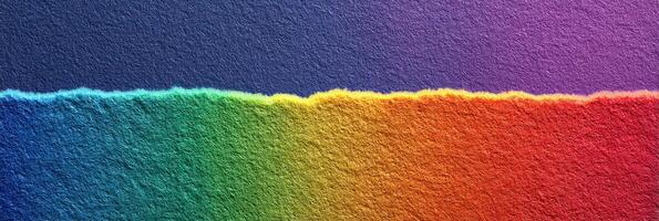 Brightly colored torn paper displaying a rainbow gradient with a textured background photo