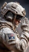 Military soldier in desert attire praying during a mission at dusk in an arid landscape photo
