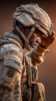 Soldier saluting during sunset at military training site while wearing combat gear and dusty uniform photo
