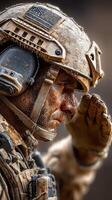 Soldier in combat gear saluting with determination on a dusty battlefield during sunrise photo