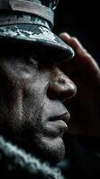 Saluting soldier with strong expression in uniform during a ceremony indoors under low lighting conditions photo