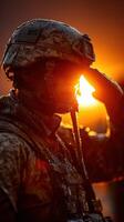 Soldier salutes against a sunset backdrop with water droplets on uniform during a military training exercise photo