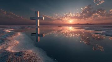 Cross stands in tranquil waters reflecting a stunning sunset over a serene landscape, evoking peace and contemplation photo