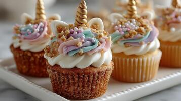 Colorful unicorn cupcakes with whimsical decorations displayed on a white plate at a festive gathering photo