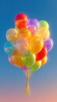 Colorful balloons floating in a clear sky during a sunny day, symbolizing joy and celebration photo