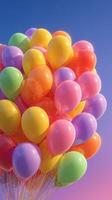 Colorful balloons floating against a bright blue sky create a festive and cheerful atmosphere with vibrant hues photo