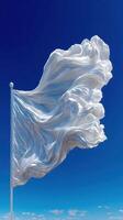 Wind-blown fabric waves gracefully above a clear blue sky in a serene landscape setting during daylight hours photo