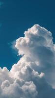 Majestic white clouds fill the bright blue sky at midday creating a stunning natural display of shapes and textures photo