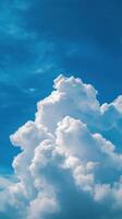 White fluffy clouds gather in the bright blue sky during a sunny afternoon photo