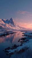 Serene winter evening at a tranquil river with majestic mountains under a clear sky photo