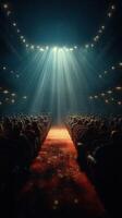 Bright lights shine on a crowded theater during a performance at night with an engaging atmosphere photo