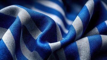 Colorful striped fabric drapes elegantly showcasing blue and white patterns in a soft texture photo