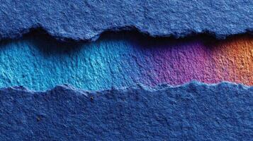 Vibrant textured paper showcasing gradient colors in blue, teal, and purple against a dark backdrop photo