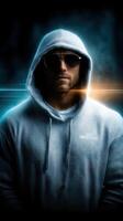 Determined individual in a hooded sweatshirt stands confidently under dramatic lighting photo