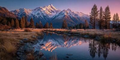 Mountains reflect in calm water at sunset in a serene landscape photo