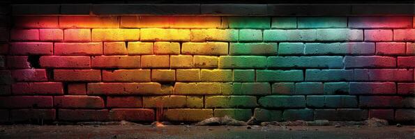 Rainbow colored brick wall illuminated in vibrant hues during evening hours for a lively urban aesthetic photo