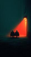 Two figures sit in darkness, illuminated by a red light from an open door on a misty night photo