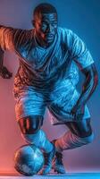 Dynamic soccer player dribbling a ball with intense focus under dramatic lighting in an indoor space photo