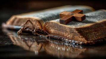 Old book with worn pages and wooden cross resting on top showcases faith and tradition in a serene environment photo