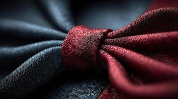 Elegant burgundy and black fabric forming a stylish knot captures luxury and sophistication in textile design for fashion enthusiasts photo