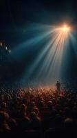 Crowd captivated by performance in a dimly lit theater with dramatic lighting at an evening event photo