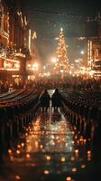 People enjoy a winter evening while sitting on chairs under festive lights and a decorated tree in a bustling square photo
