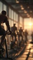 Cyclists workout at sunrise in a modern gym with floor-to-ceiling windows overlooking the city photo