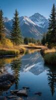 Serene mountain landscape with a reflective river and autumn foliage during a clear day photo