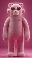 Cute pink teddy bear wearing heart-shaped sunglasses and headphones stands against a vibrant pink background photo