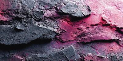 Colorful textured wall with layers of grey and pink under sunlight in an urban setting photo