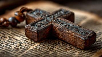 Unique wooden cross resting on ancient book pages with intricate details captured in warm lighting photo
