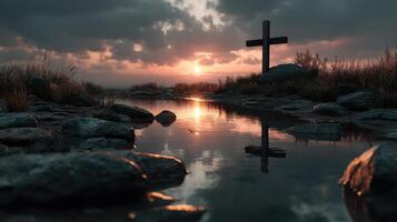 Sunset over a tranquil lake reflecting a cross silhouette and rocks in a serene natural landscape photo
