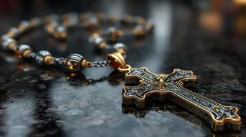 Ornate golden cross pendant resting on black marble counter illuminated by soft light photo
