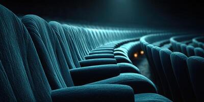Rows of velvet theater seats illuminated by soft light create an inviting atmosphere for the audience during a performance photo