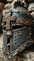 Medieval knight helmet with intricate cross detail showcased in an ancient setting photo