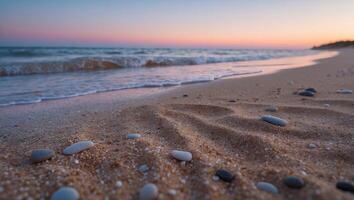 Stones on Sandy Beach at Sunset with Soft Waves and Colors photo