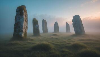 Standing Stones Misty Morning Landscape Ancient Rock Formations on Grassy Field photo