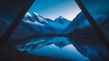 Snowy Mountain Peaks Reflecting in Calm Lake Under Clear Blue Sky photo