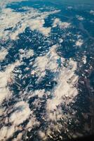 Clouds Over The Snowy Mountains From Above photo